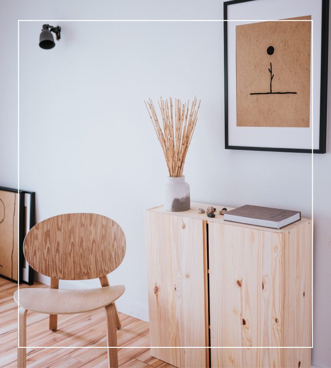 A chair and some plants in a room.